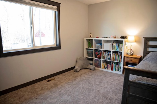 carpeted bedroom with visible vents and baseboards