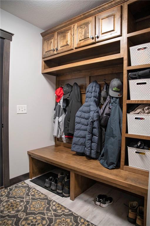 mudroom with a textured ceiling