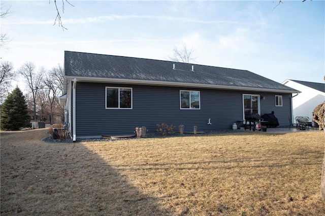 back of house featuring a lawn and a patio