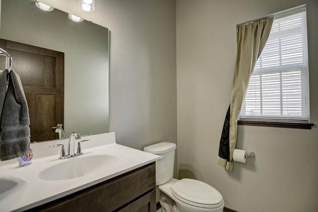 bathroom featuring toilet and vanity