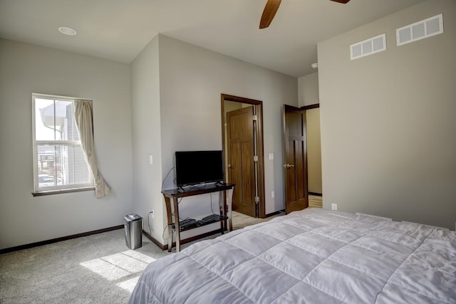 bedroom with visible vents, carpet floors, baseboards, and a ceiling fan