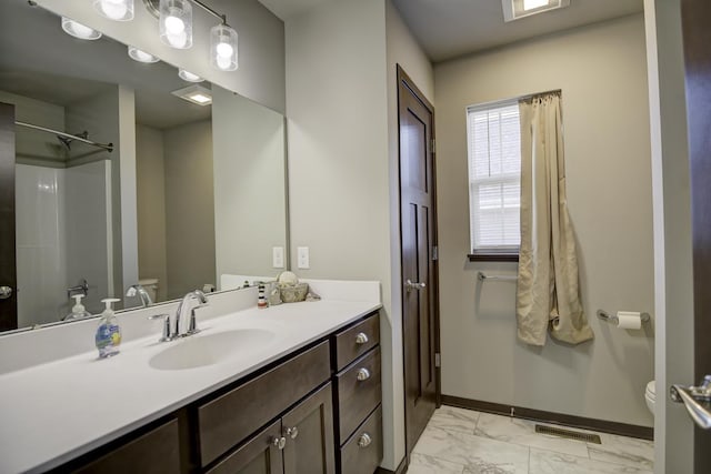 bathroom with visible vents, toilet, marble finish floor, baseboards, and vanity