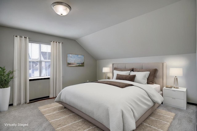 bedroom with light colored carpet, baseboards, and lofted ceiling