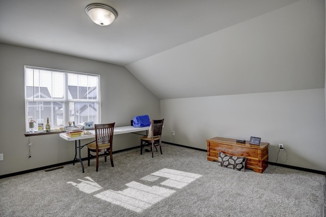 office space with visible vents, baseboards, carpet floors, and vaulted ceiling