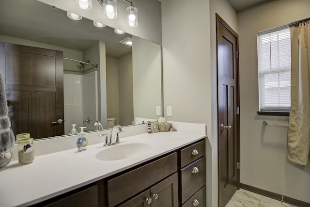 full bath with baseboards, walk in shower, toilet, marble finish floor, and vanity