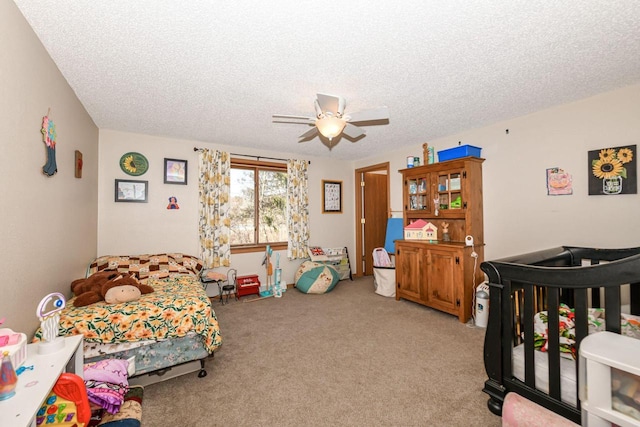 bedroom with light carpet, a textured ceiling, and a ceiling fan