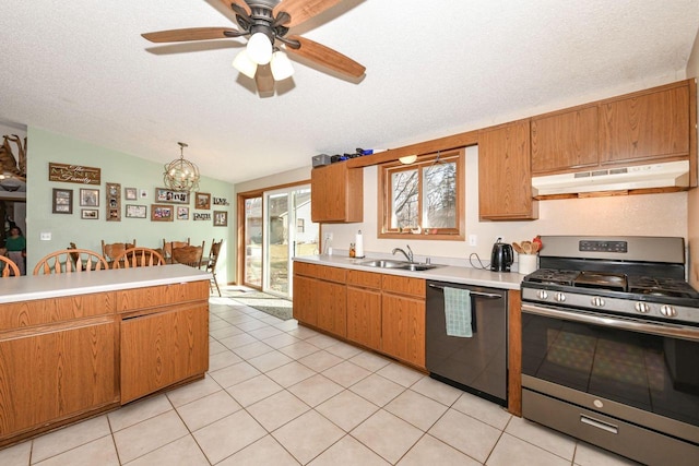 kitchen with dishwashing machine, stainless steel range with gas stovetop, a sink, light countertops, and under cabinet range hood