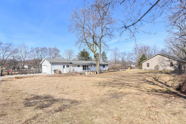 rear view of house featuring an attached garage