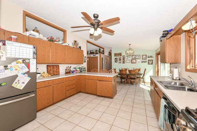 kitchen with a sink, stainless steel appliances, lofted ceiling, and light countertops