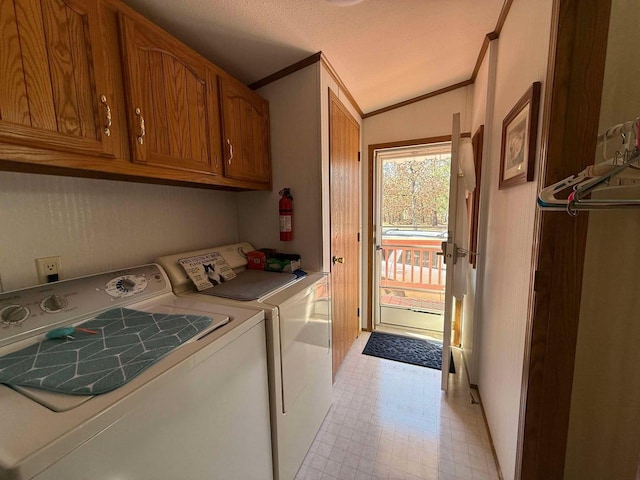 washroom featuring cabinet space, independent washer and dryer, light floors, and ornamental molding