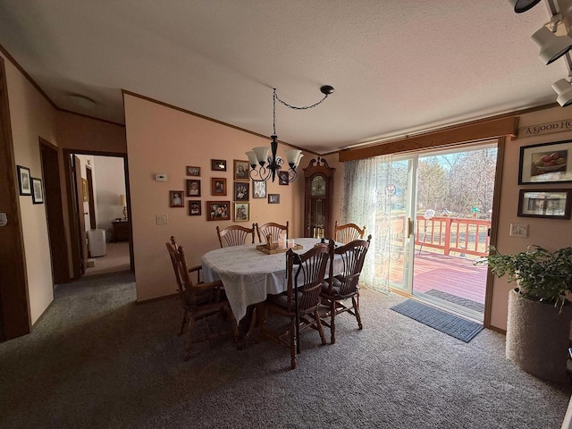 carpeted dining room featuring a textured ceiling, a chandelier, and crown molding