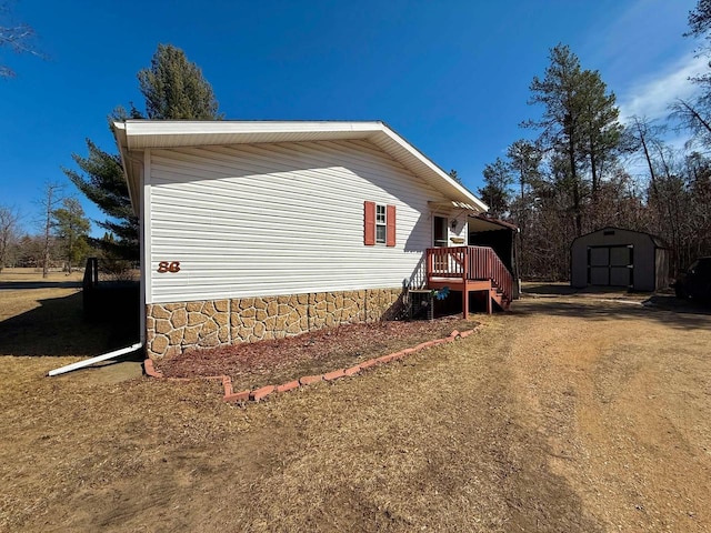 view of side of home featuring a storage shed, central AC unit, and an outdoor structure