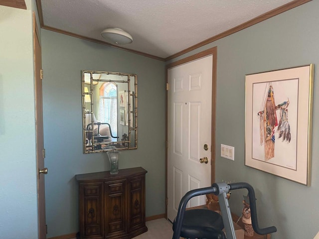 foyer entrance featuring a textured ceiling and crown molding