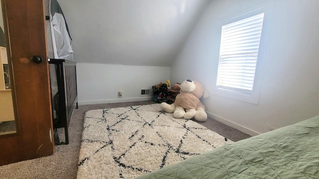 bedroom featuring visible vents, carpet floors, baseboards, and vaulted ceiling