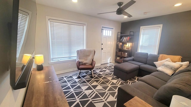 living room featuring recessed lighting, baseboards, and a healthy amount of sunlight