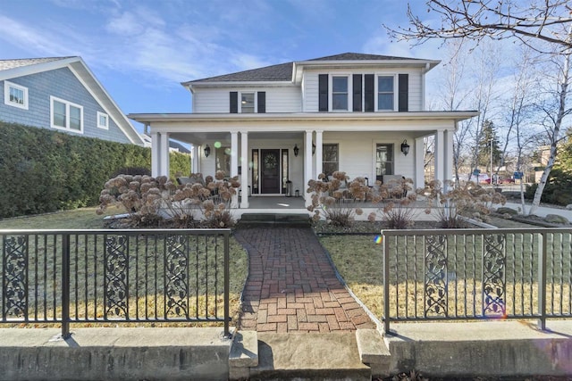 view of front of house featuring a fenced front yard, covered porch, and a shingled roof