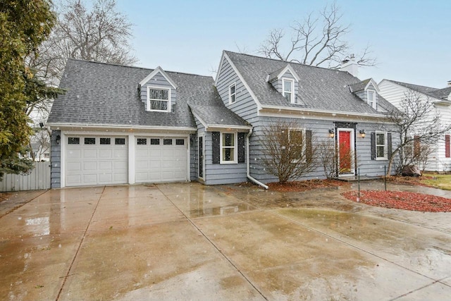 cape cod-style house featuring concrete driveway, an attached garage, and roof with shingles