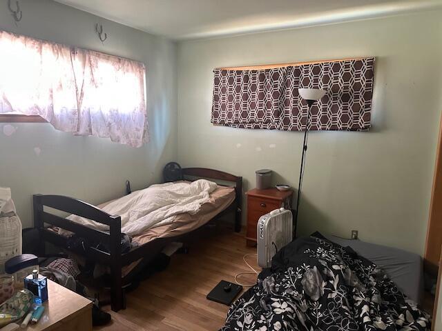 bedroom with wood finished floors