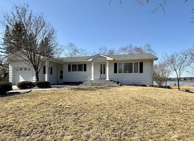 single story home with a water view, a front yard, and an attached garage