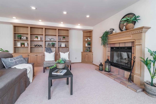 living room with recessed lighting, baseboards, light colored carpet, and a fireplace