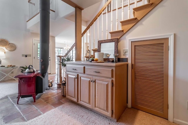 bar featuring a sink, a chandelier, and stairs