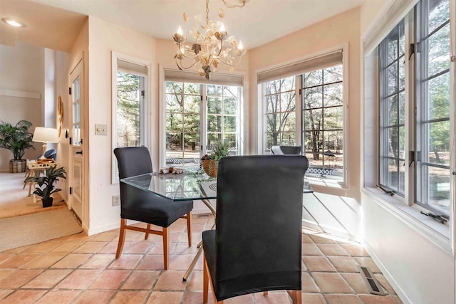 dining space featuring a notable chandelier, baseboards, and visible vents