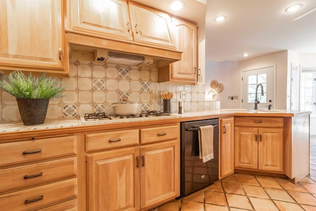 kitchen featuring white gas cooktop, a peninsula, a sink, tile counters, and black dishwasher