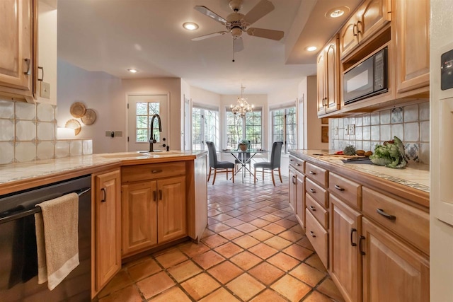 kitchen with tile countertops, dishwasher, a peninsula, and black microwave