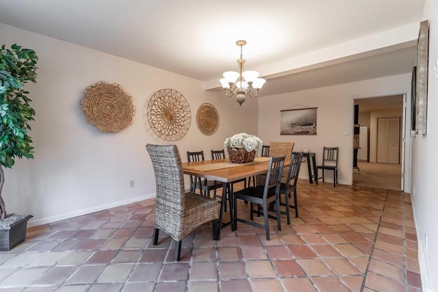 dining area featuring tile patterned floors, baseboards, and an inviting chandelier