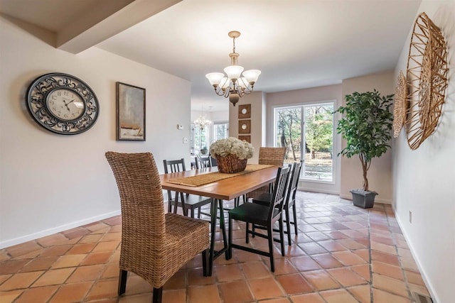 dining room with light tile patterned flooring, visible vents, baseboards, and a chandelier