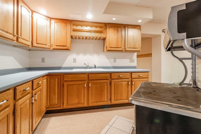 kitchen featuring a sink, range with electric cooktop, recessed lighting, and light countertops