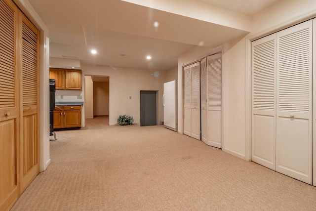 interior space with recessed lighting, baseboards, and light carpet