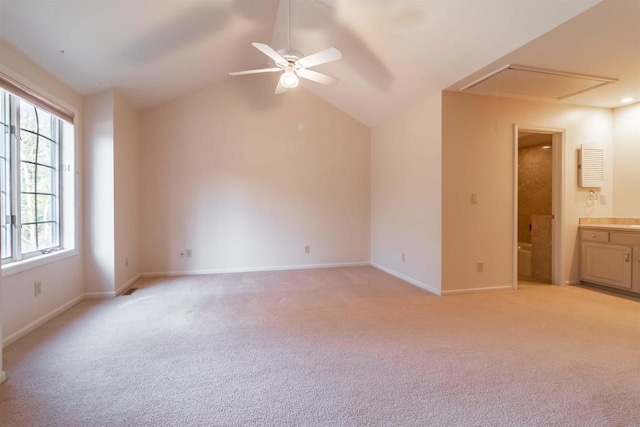 empty room featuring baseboards, lofted ceiling, light colored carpet, and a ceiling fan