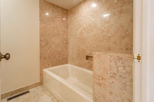 full bathroom with tile patterned floors, visible vents, and a tub to relax in