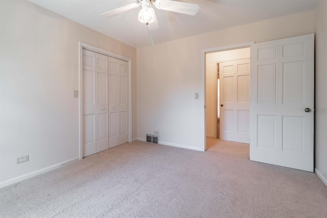 unfurnished bedroom with visible vents, a ceiling fan, a closet, carpet floors, and baseboards