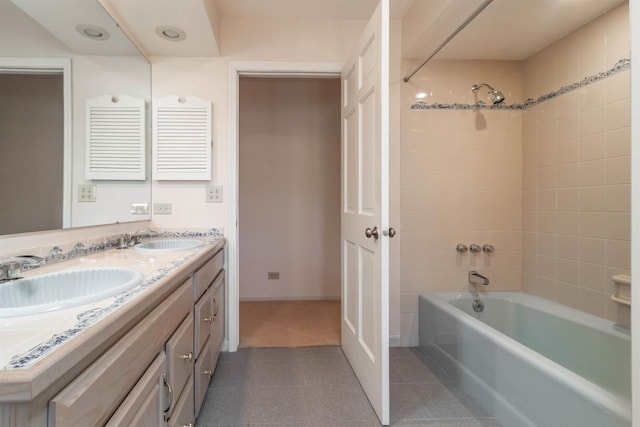 bathroom featuring double vanity, tub / shower combination, tile patterned floors, and a sink