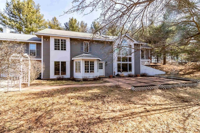 back of house with a patio area and a chimney