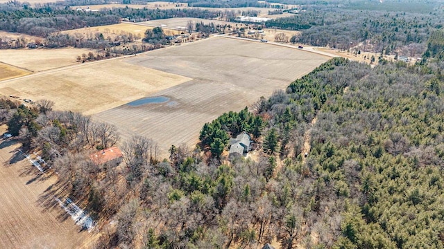 birds eye view of property with a view of trees and a rural view