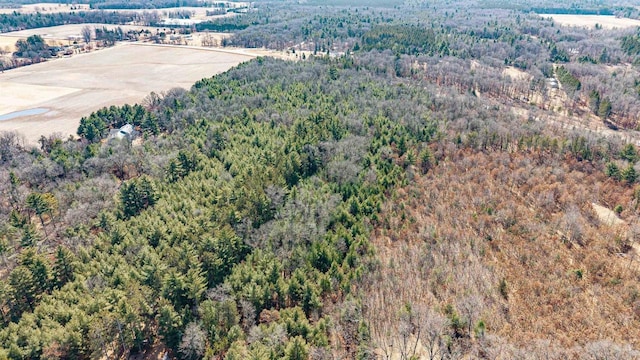 drone / aerial view featuring a wooded view