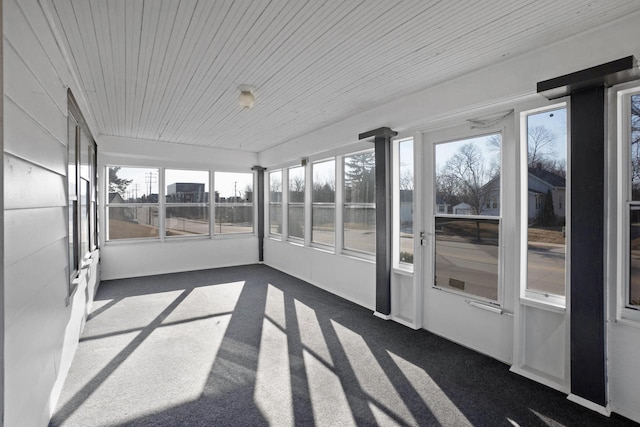 unfurnished sunroom featuring wood ceiling