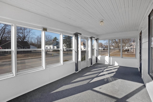 unfurnished sunroom featuring wood ceiling