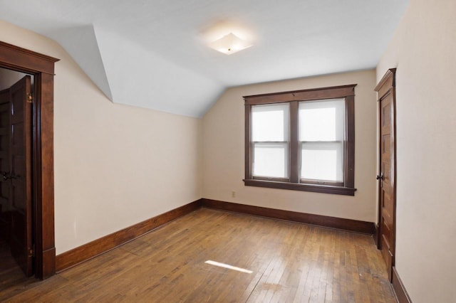 bonus room featuring vaulted ceiling, baseboards, and wood-type flooring