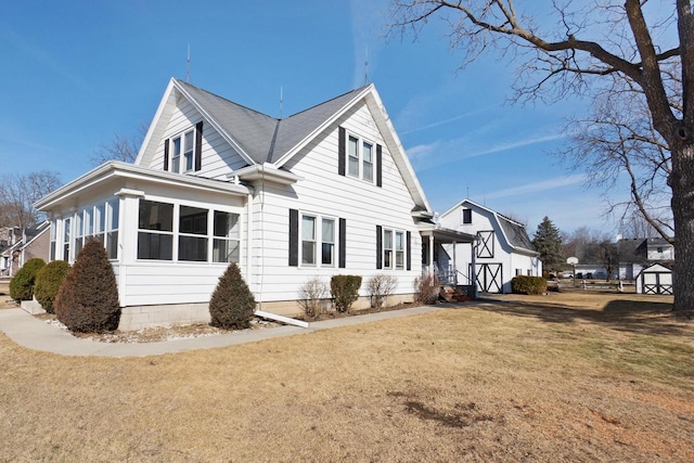 view of side of property with a lawn