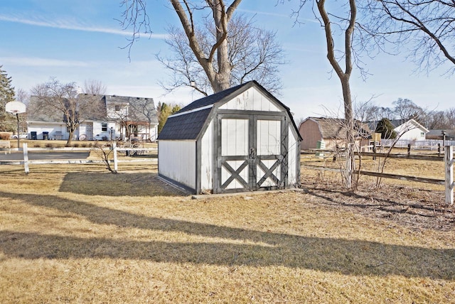 view of shed featuring fence