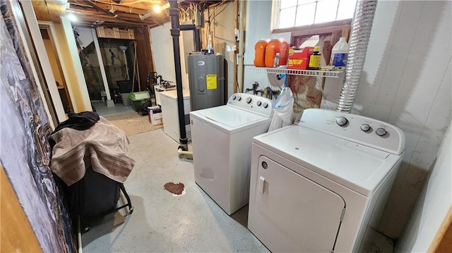 washroom with laundry area, washing machine and dryer, and electric water heater