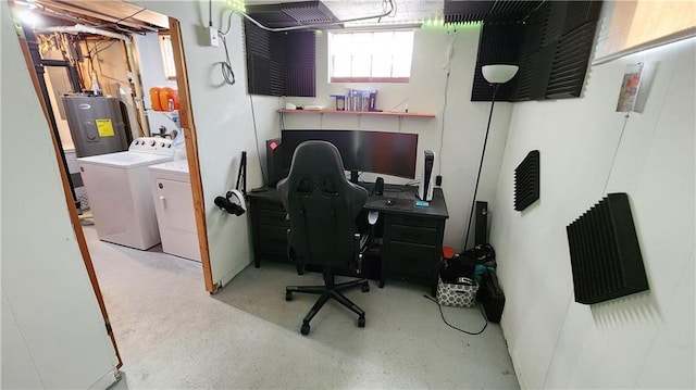 home office featuring speckled floor, water heater, and washer and clothes dryer