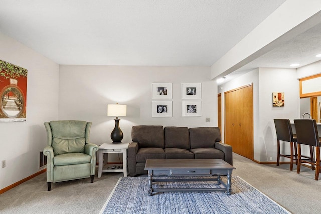 carpeted living room with baseboards