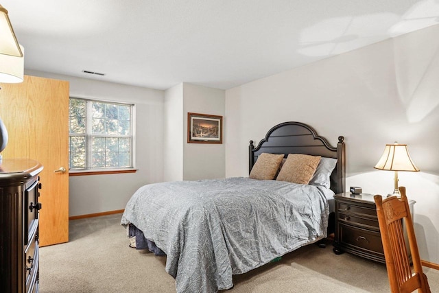 carpeted bedroom with baseboards and visible vents