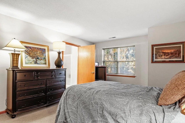 bedroom featuring light carpet and visible vents