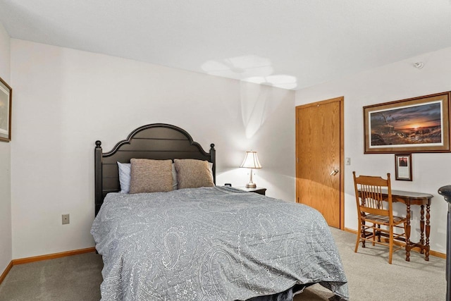 bedroom featuring light carpet and baseboards